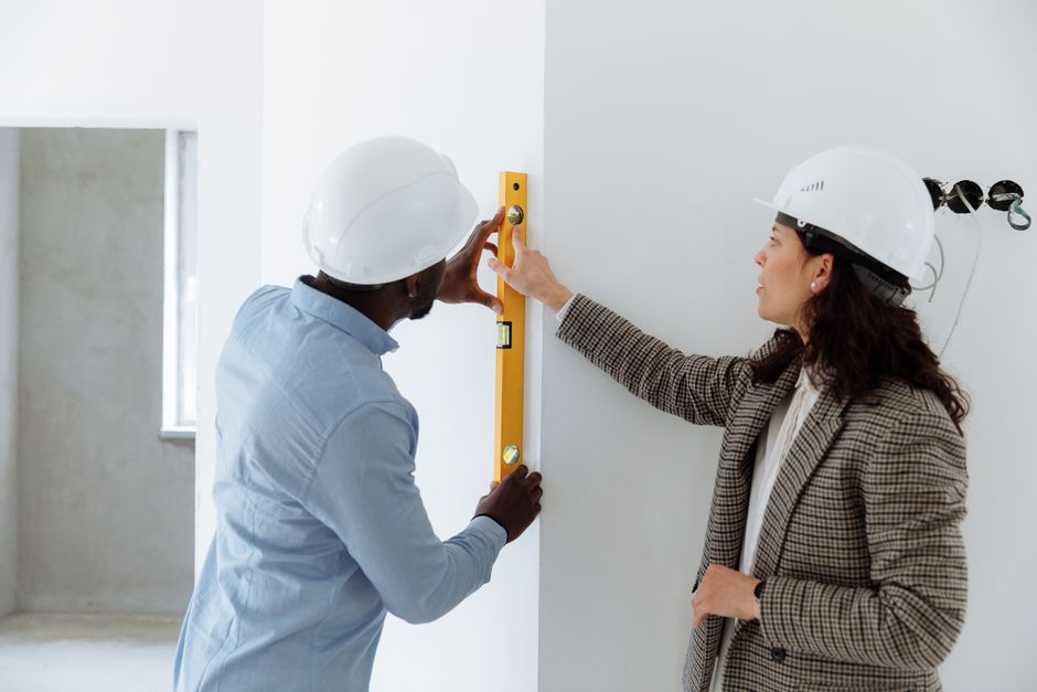 Friendly construction contractor reviewing house plans